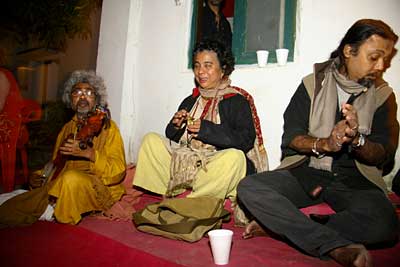 The Baul singer Paban Das and musicians seated on a rug, New Year party 2007–08