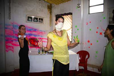 Guests decorating the party room with paint and streamers