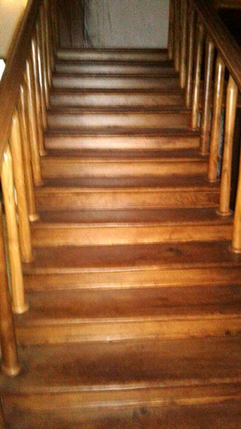 The polished wooden steps of the staircase