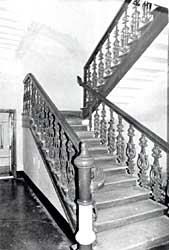The old staircase and its carved railing, in black and white