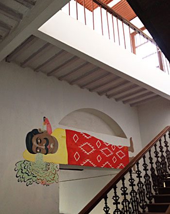 The staircase, with a painted figure on the wall