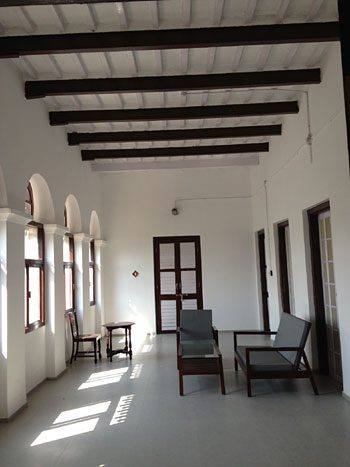 The long verandah with its beamed ceiling and arched windows