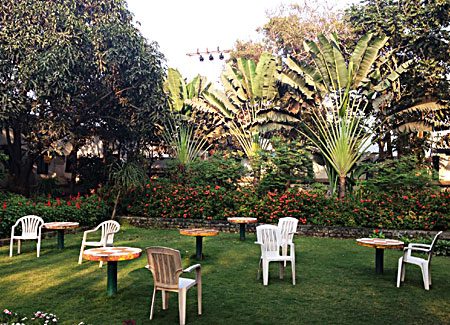 The garden with tables and chairs on the lawn