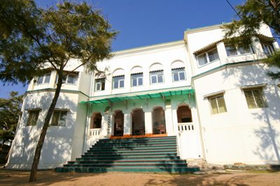 The front of the Z Hotel, white with green awnings, and its wide steps