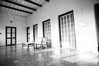 A room with tall windows, in black and white