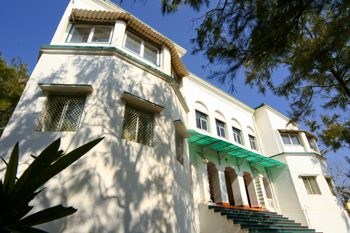 The white walls and green awnings of the hotel, seen from below