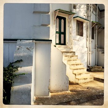 An outside staircase on the white walls of the house